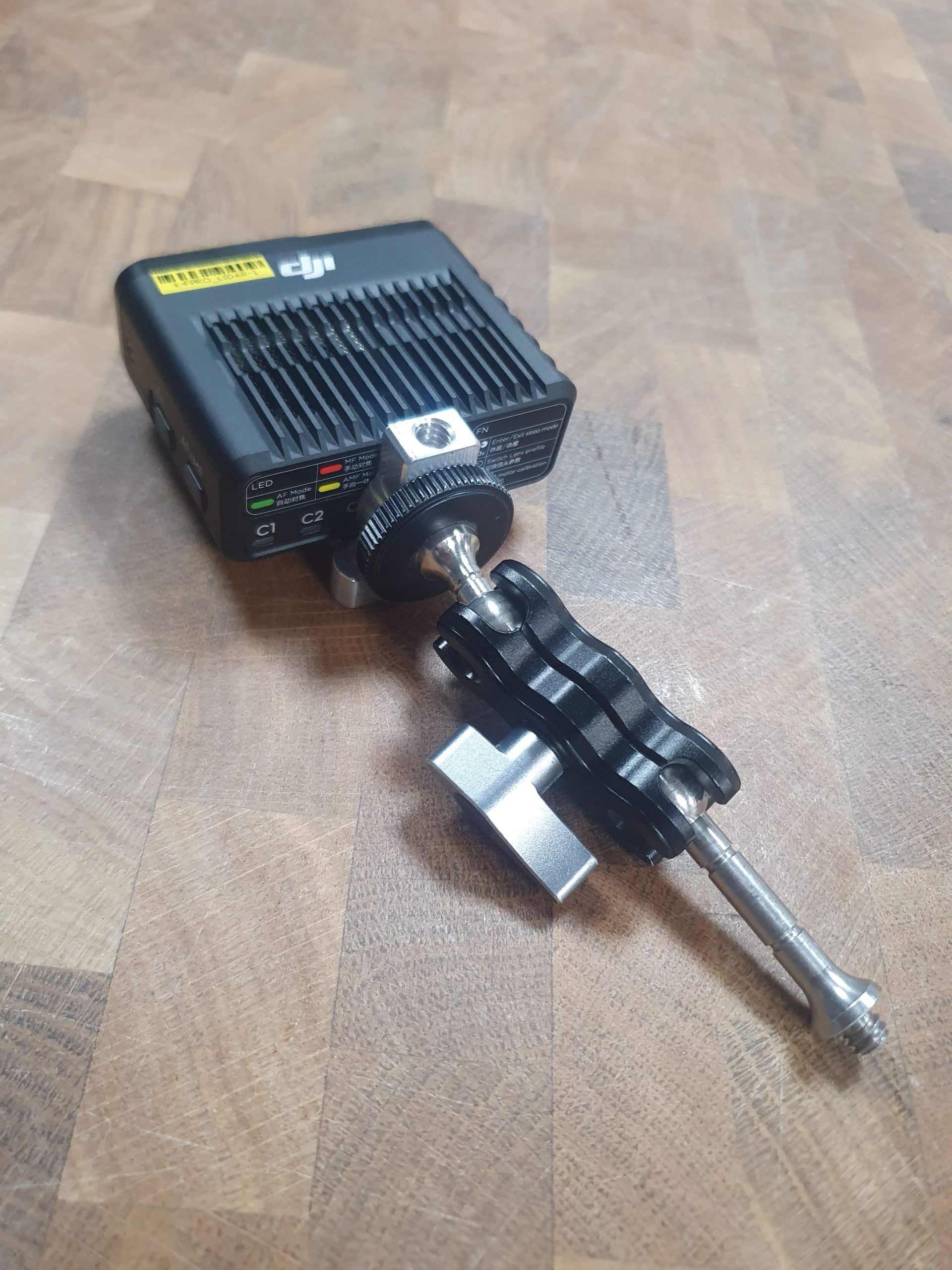 DJI Focus Pro LiDAR accessory plate mounted on a magic arm for flexible positioning.